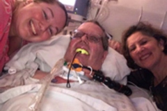 patient on a ventilator machine with his family